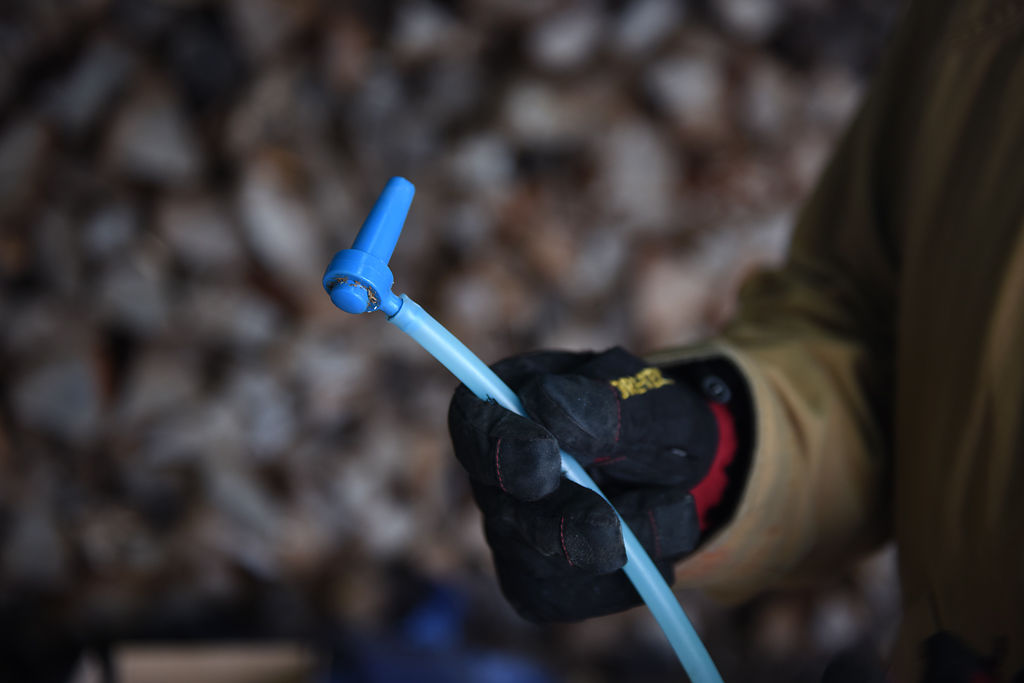 Benjamin Knapp displays a plastic spigot